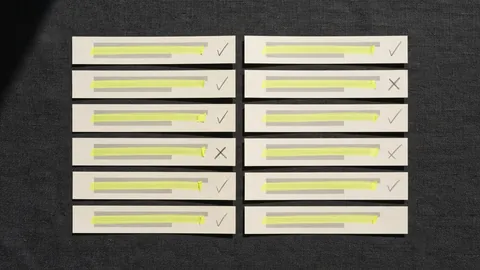 Strips of a printed answer laid out in two columns, each marked in yellow and ticked or crossed in pencil