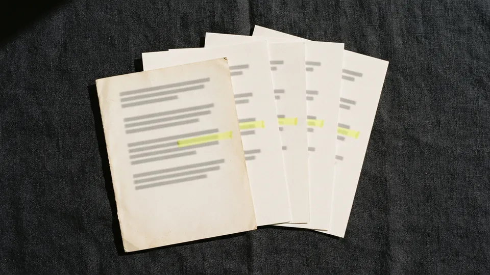 A fanned stack of printed pages with the same line marked in yellow on each, the front sheet older and yellowed