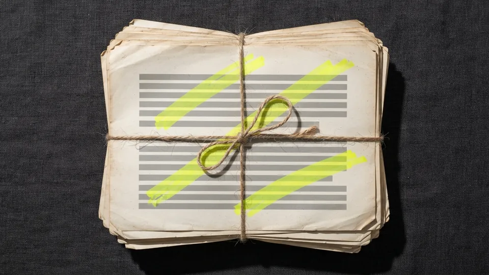 A stack of faded, curled old pages with yellow marks, tied with string