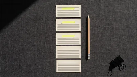 A column of five index cards laid out like a bibliography, three of them with a yellow highlighter stroke on the top line, a pencil beside them