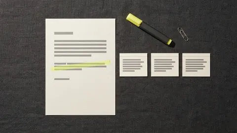 A printed web page with one sentence highlighted beside three small citation cards and a highlighter pen on a charcoal desk